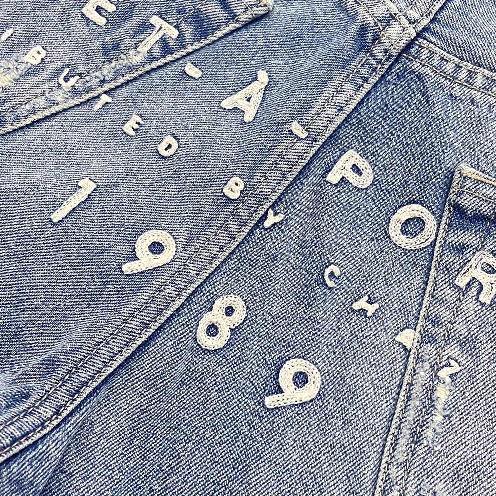 702 Embroidered Logo Denim Jeans
